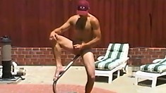 Lusty muscular gayboy in red cap masturbates in his back yard